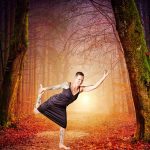 Sabine Scholze steht in der Figur der Tänzerin (Yoga)vor einer Waldkulisse.